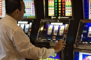 Pic AC gambler plays slot machine
